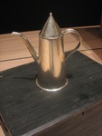 Metalworking Symposium.  18th century coffeepot copied from original piece found in well at CW -- also pictured in original Delft tile.  Made completely with hand tools only